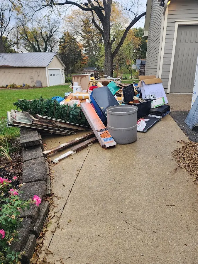 Dumpster being loaded with debris for Roofing Dumpster Rental in Wells
